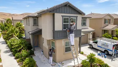 Professional house painters working on exterior home repaint in Las Vegas NV